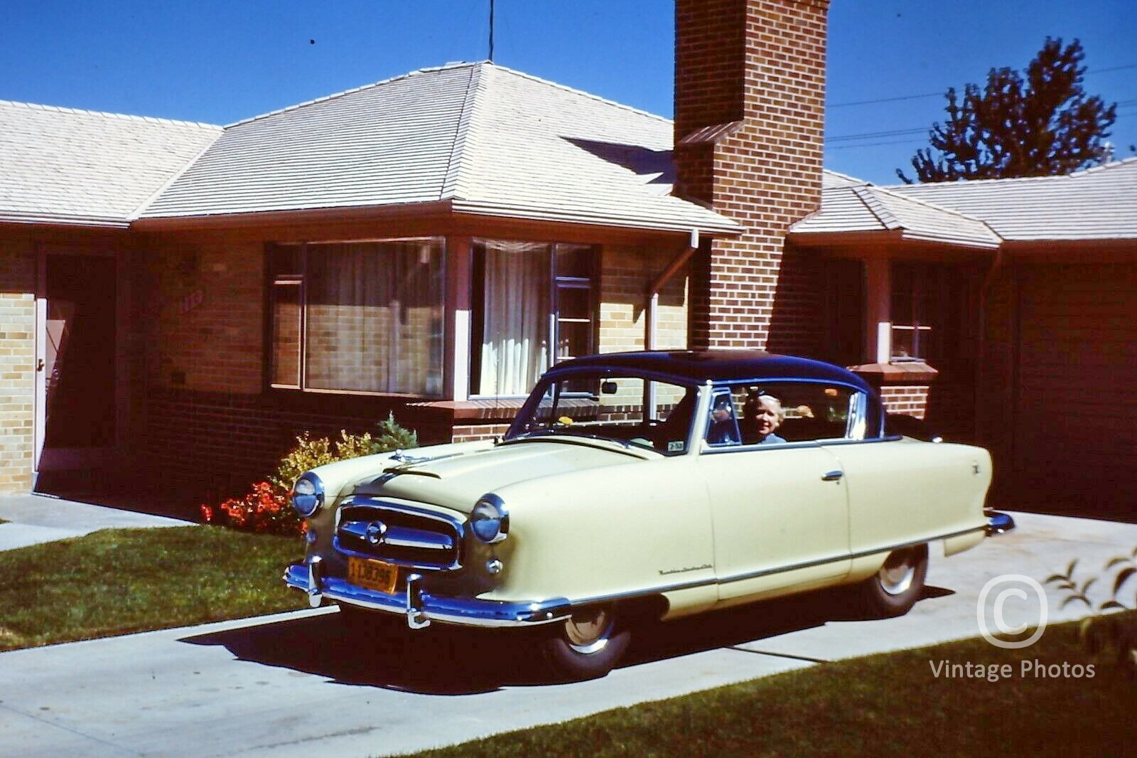 1950s Classic Automobile Coupe Yellow - in Driveway - Lady Driver